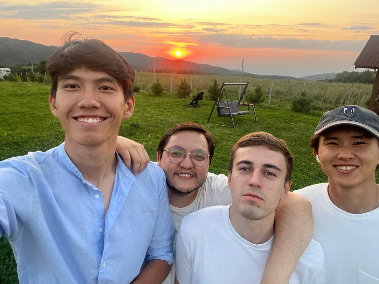 Four friends outside at sunset