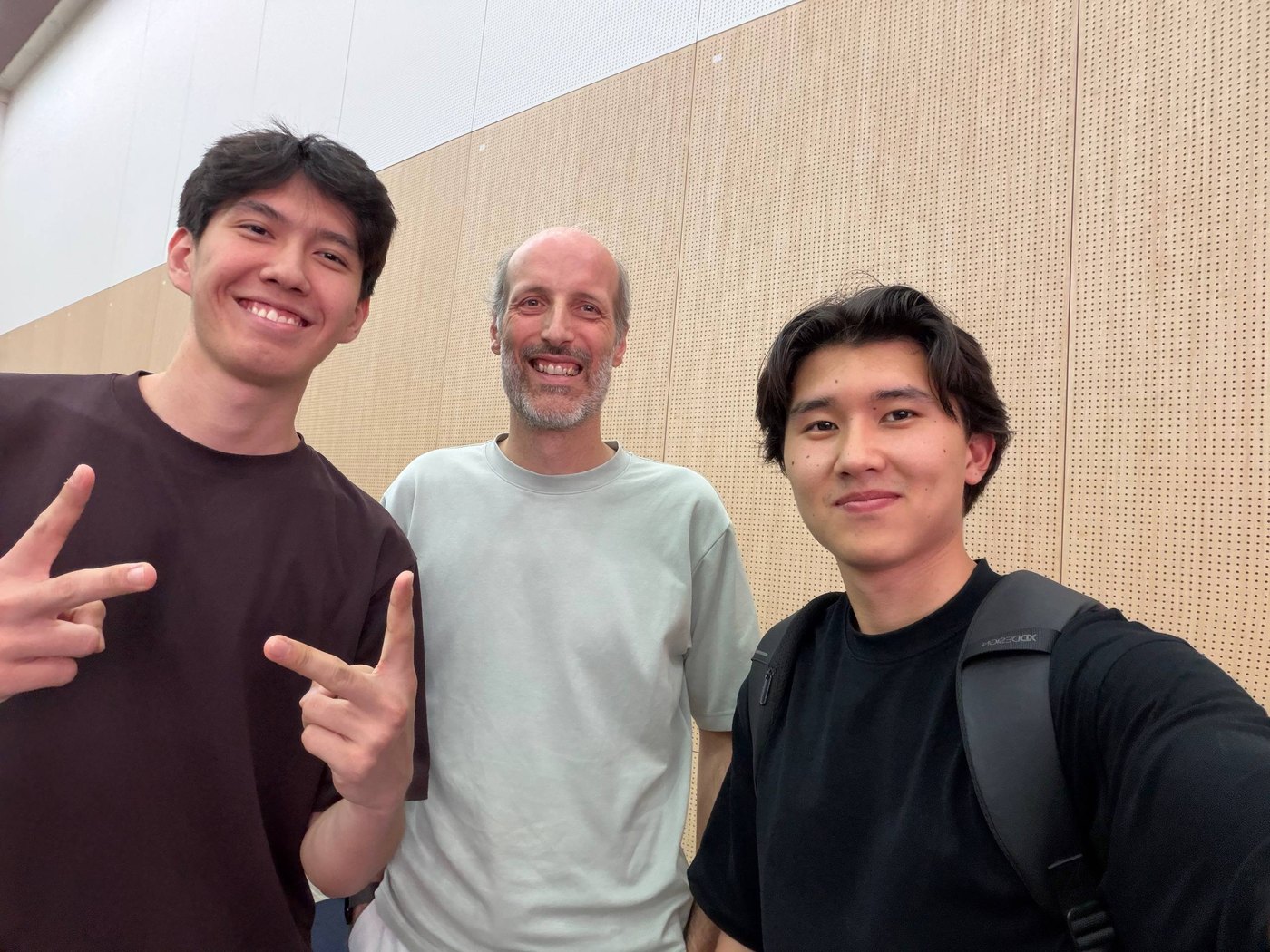 Three people smiling for a photo indoors