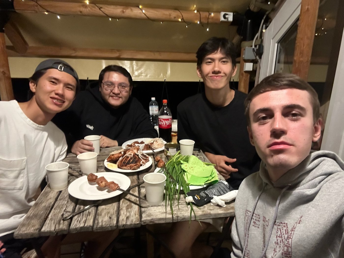 Four friends sharing dinner around a table